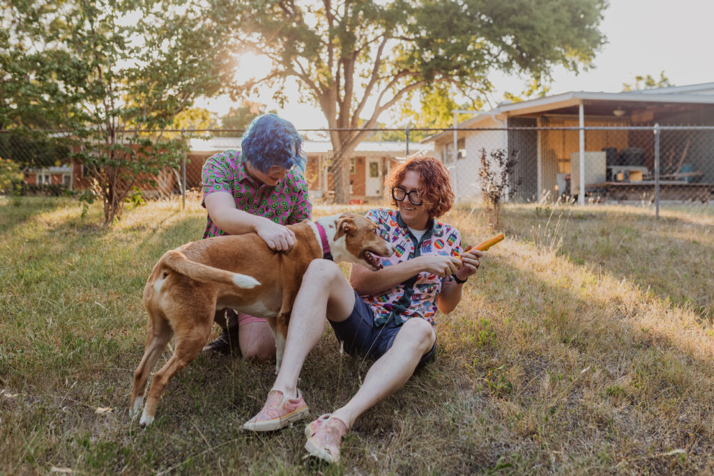 couple with their dog in their backyard