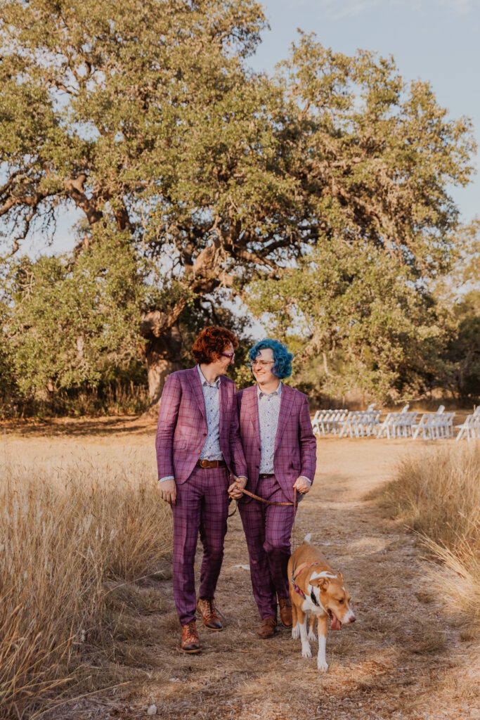 Couple walking with dog at wedding