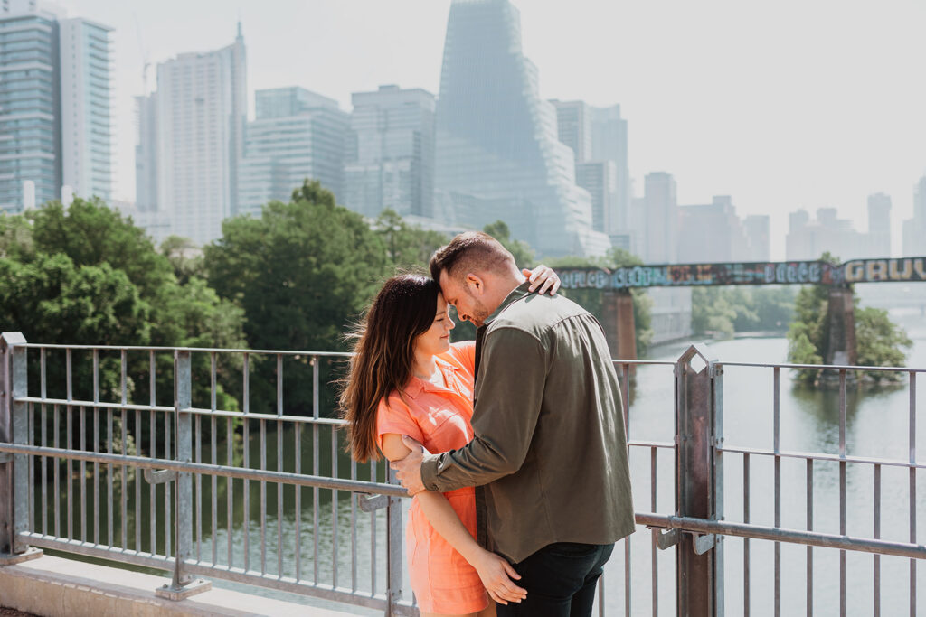 couple taking engagement photo on pfluger pedestrian bridge