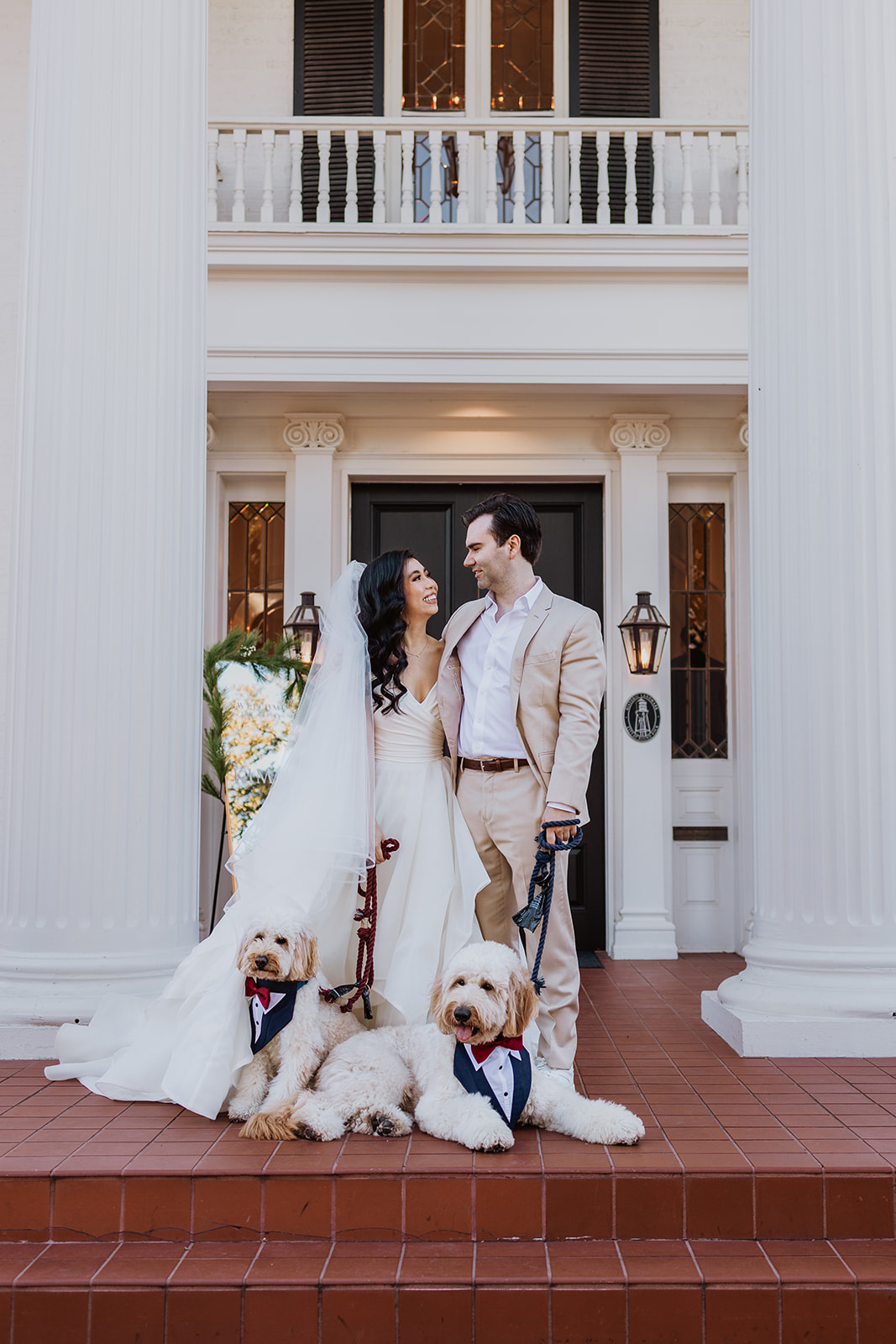 Couple posing at Christmas-themed brunch wedding at Woodbine Mansion