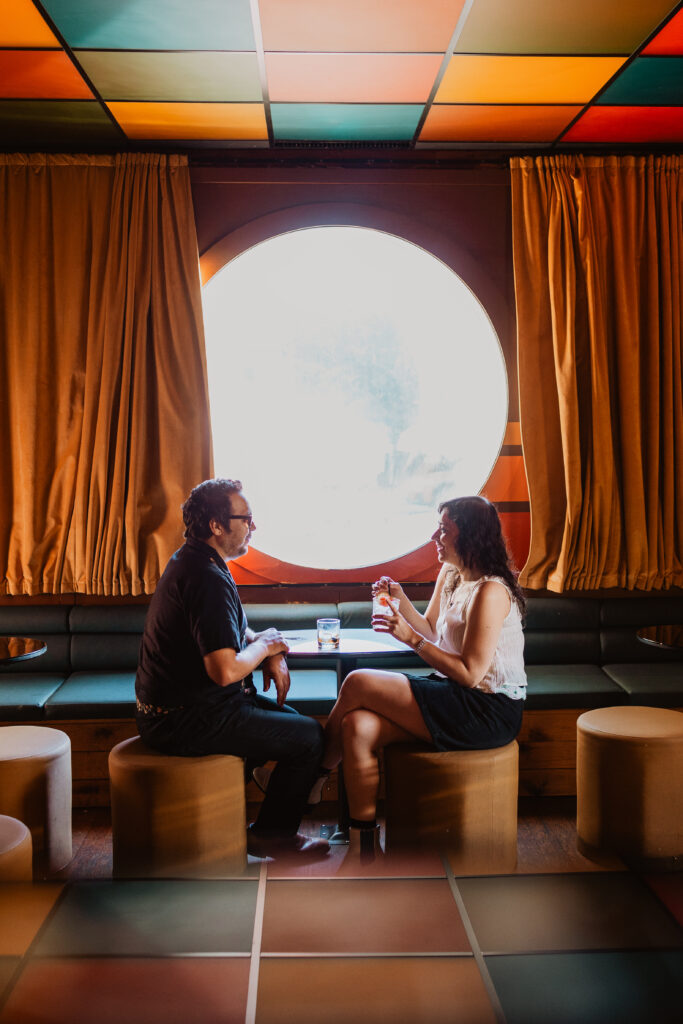 couple inside bar posing for engagement photo