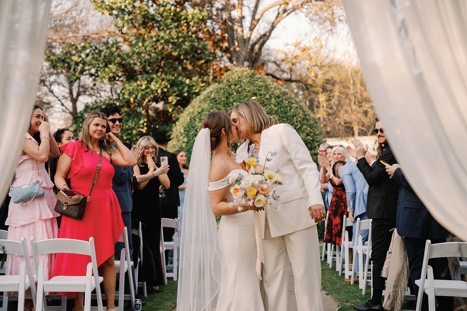 Couple kissing at wedding ceremony at Hummingbird House - one of many Austin wedding venues