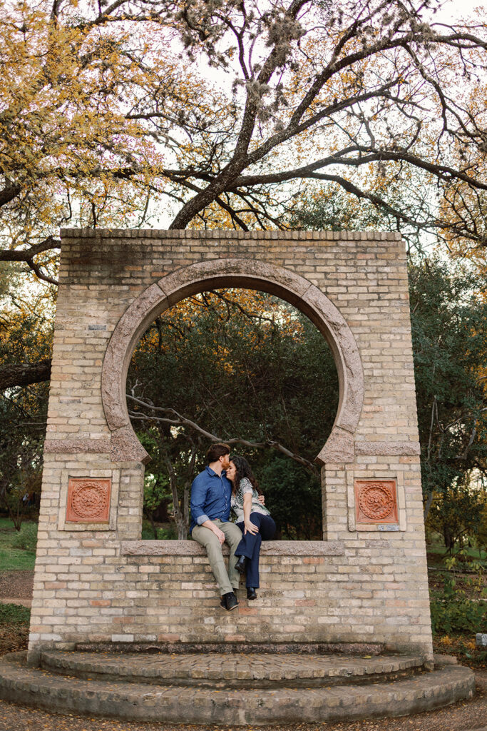 Couple poses for engagement photos at the Zilker Botanical Gardens