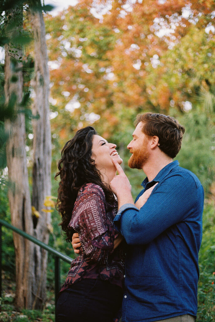 Couple poses for engagement photos at the Zilker Botanical Gardens