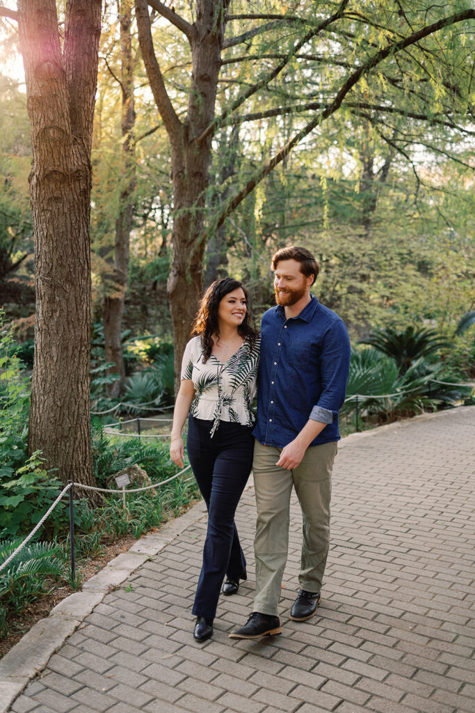 Couple poses for engagement photos at the Zilker Botanical Gardens