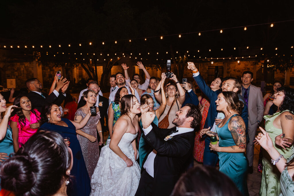 Guests dancing to Love Story by Taylor Swift at a wedding reception at the LBJ Wildflower Center