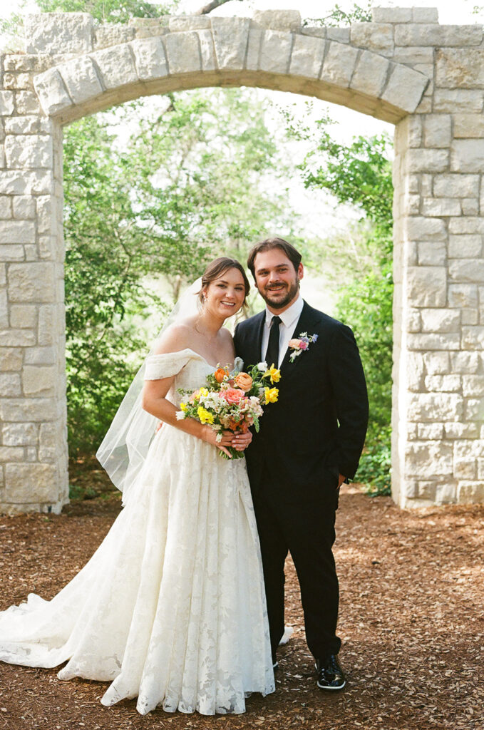 Couple poses in front of Cecille's Arch at the LBJ Wildflower Center