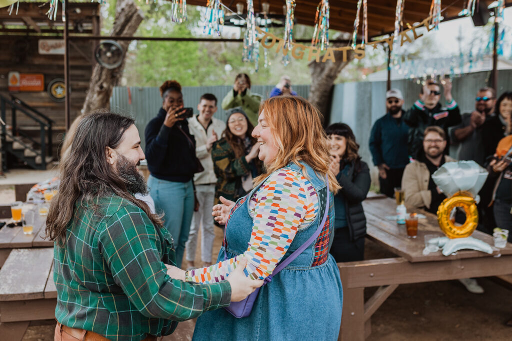 Couple arrives to a party celebrating their engagement at Little Darlin in Austin, Texas. Cameron knew how to propose in Austin in a way that was unique to his relationship.