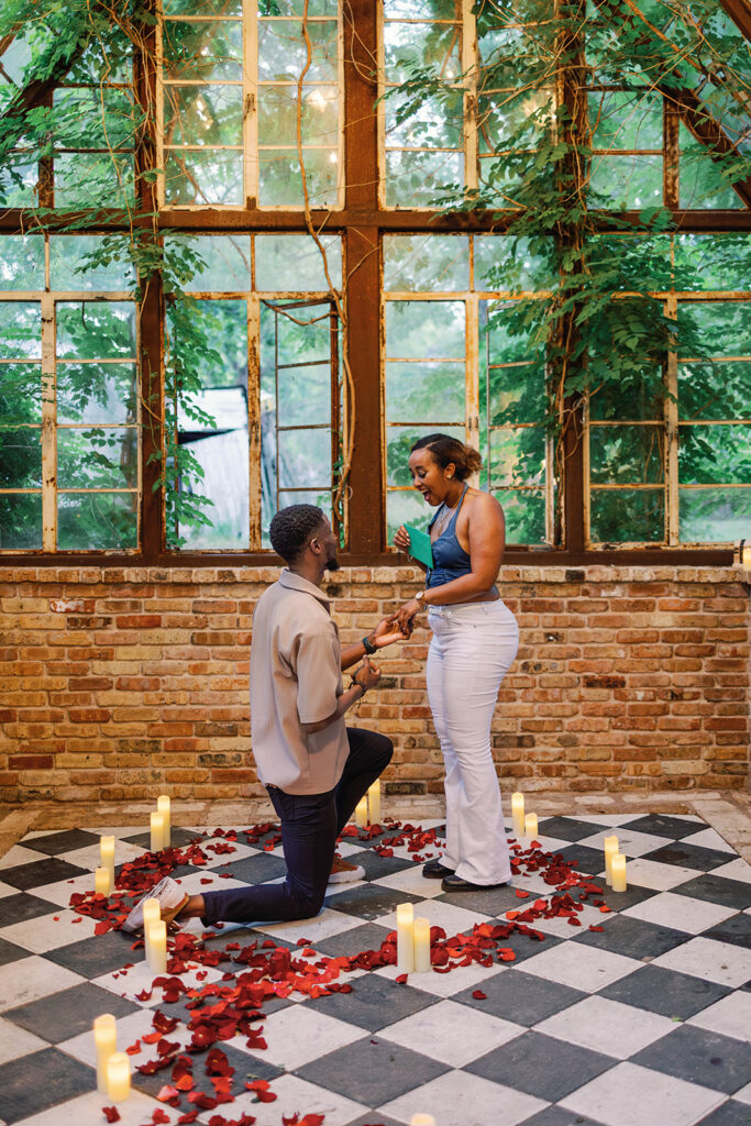 Man proposing to his girlfriend inside Sekrit Theater's glass greenhouse in Austin, Texas