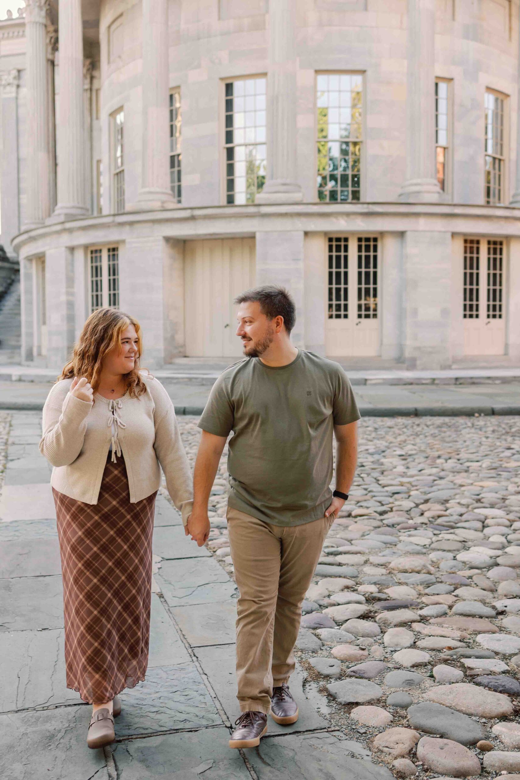 Couple poses for photos in front of the Merchant Exchange Building in Old City Philadelphia