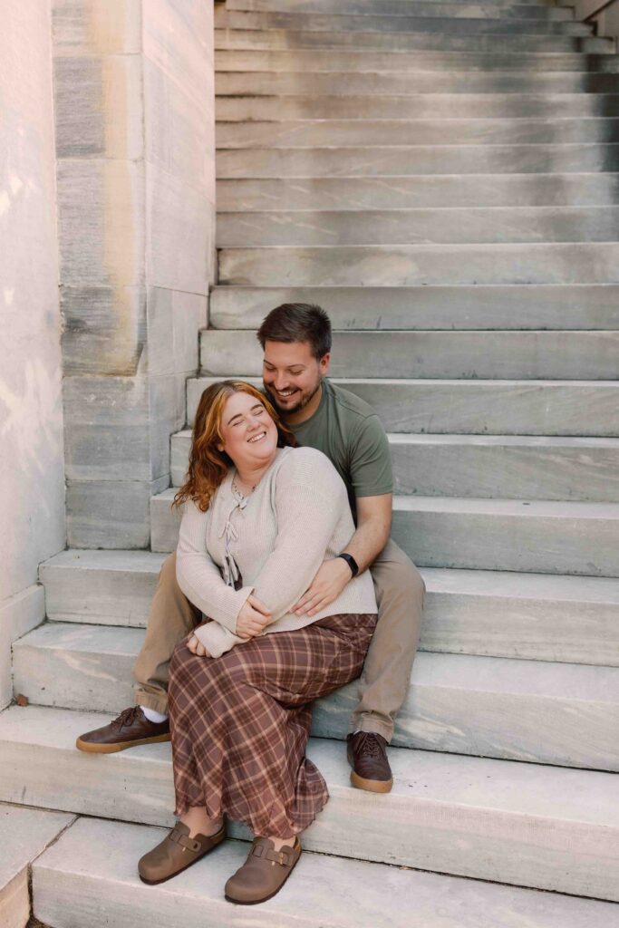 Couple poses for photos in front of the Merchant Exchange Building in Old City Philadelphia