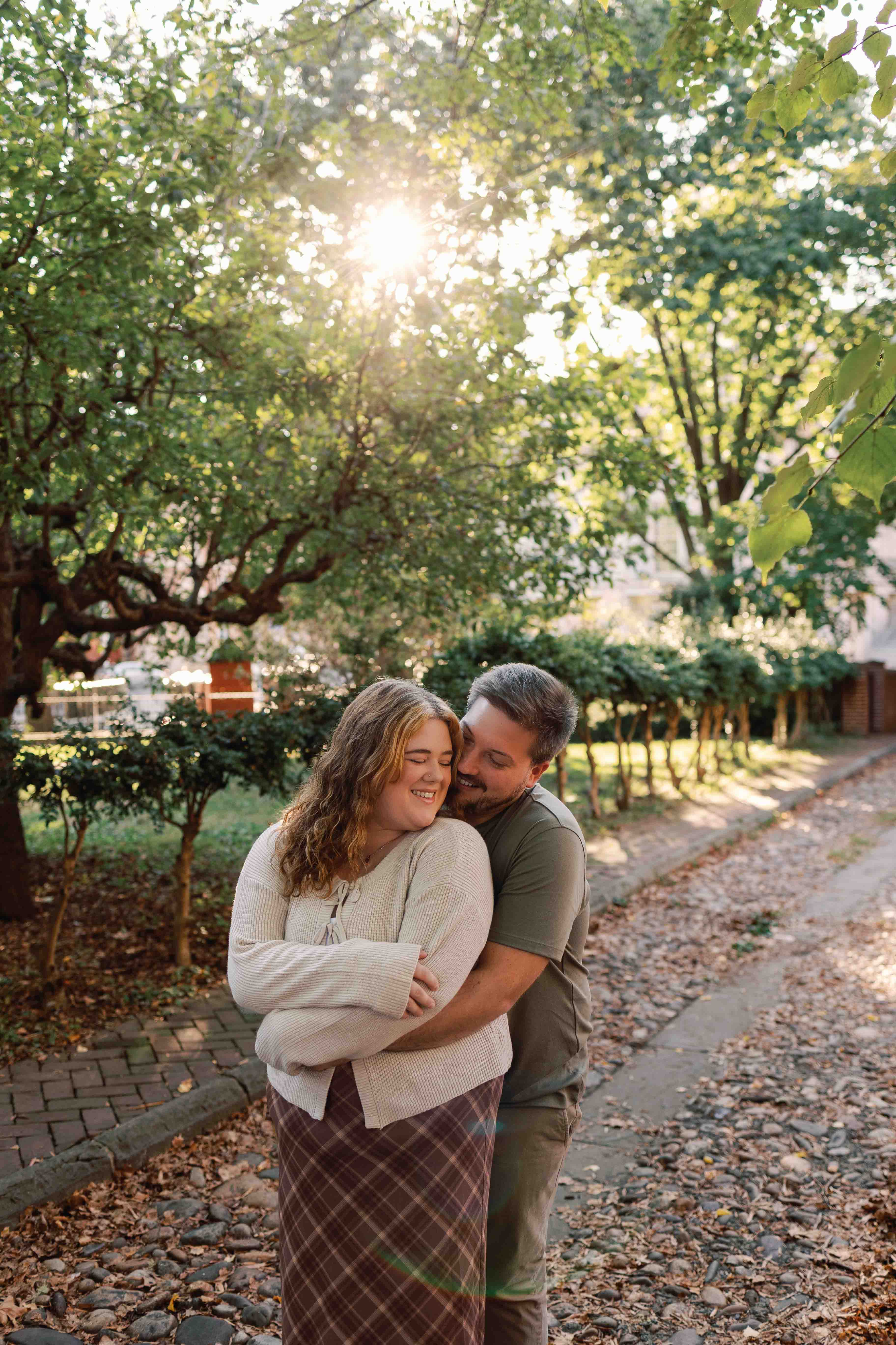 Couple poses for photos on historic cobblestone streets in Philadelphia