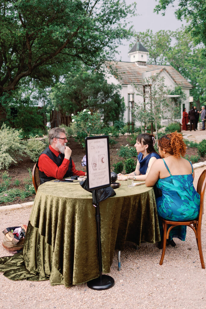 wizard doing tarot and palm readings at fantasy-inspired wedding 