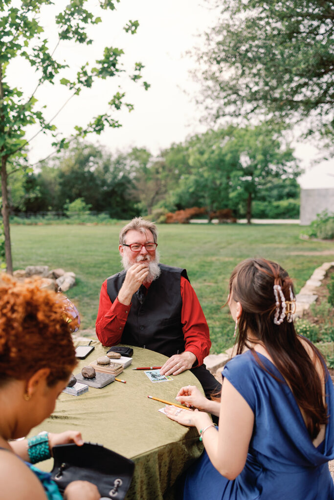 wizard doing tarot and palm readings at fantasy-inspired wedding 