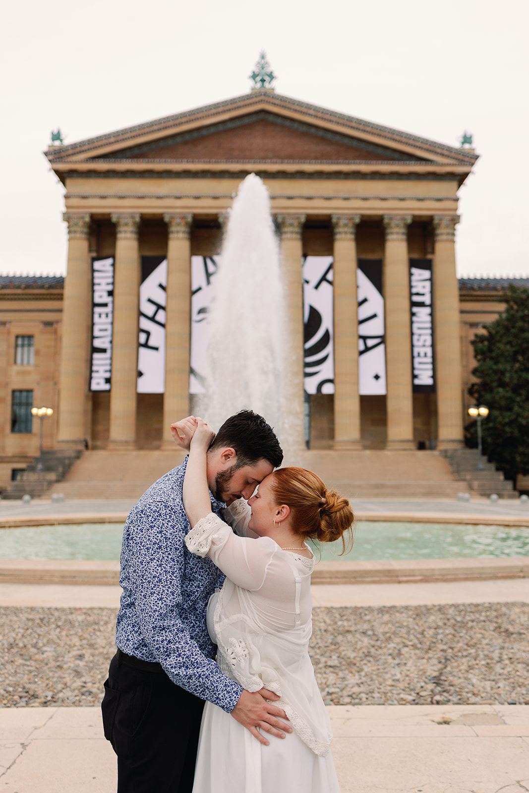 Couple poses for photos in front of the Philadelphia Museum of Art